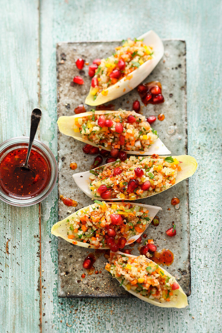 Bulgur salad with pomegranate seeds in chicory boats