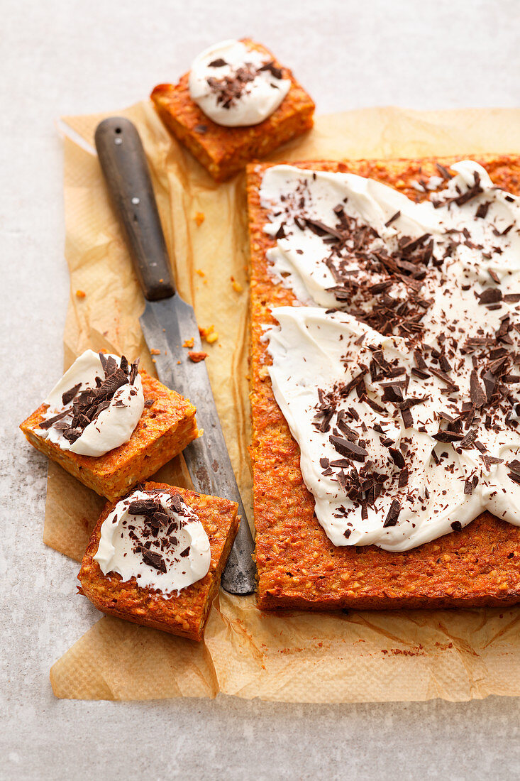 Nut and carrot slices topped with chocolate and cream