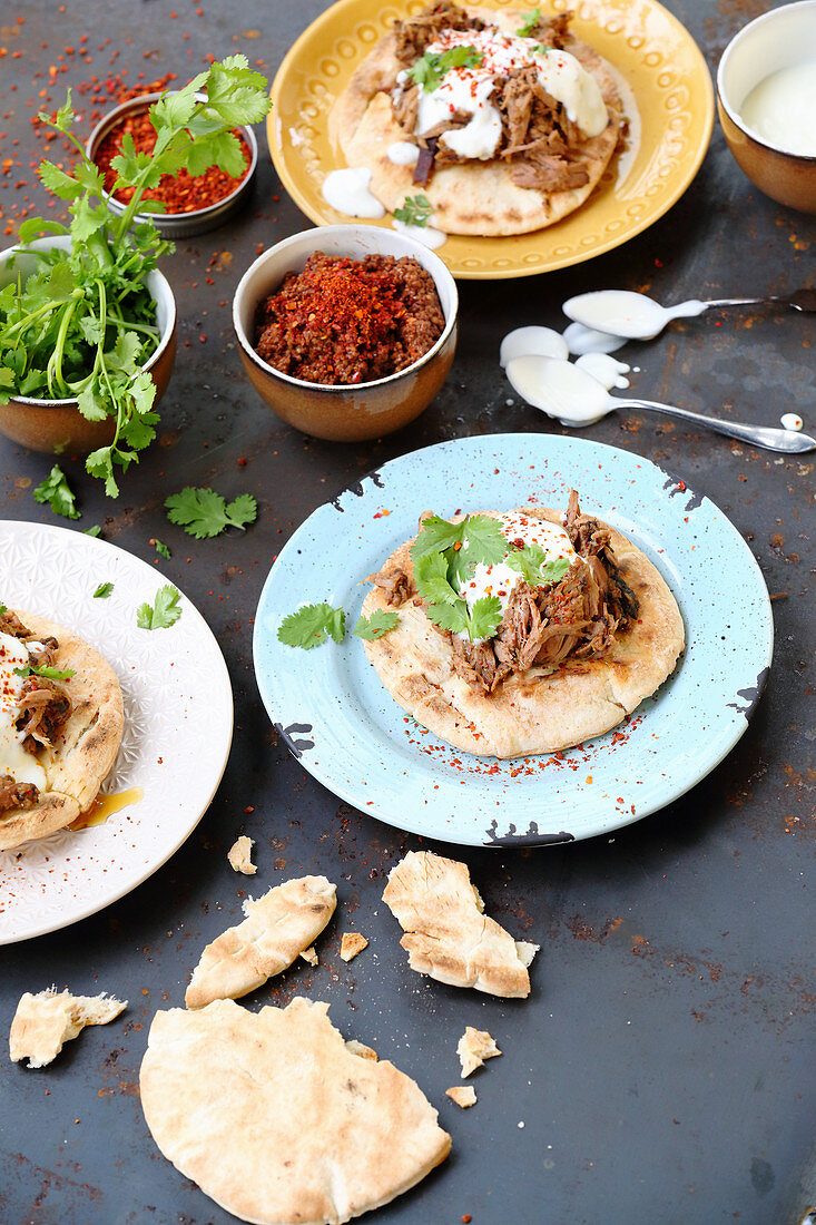 Grilled pitta breads with pulled lamb