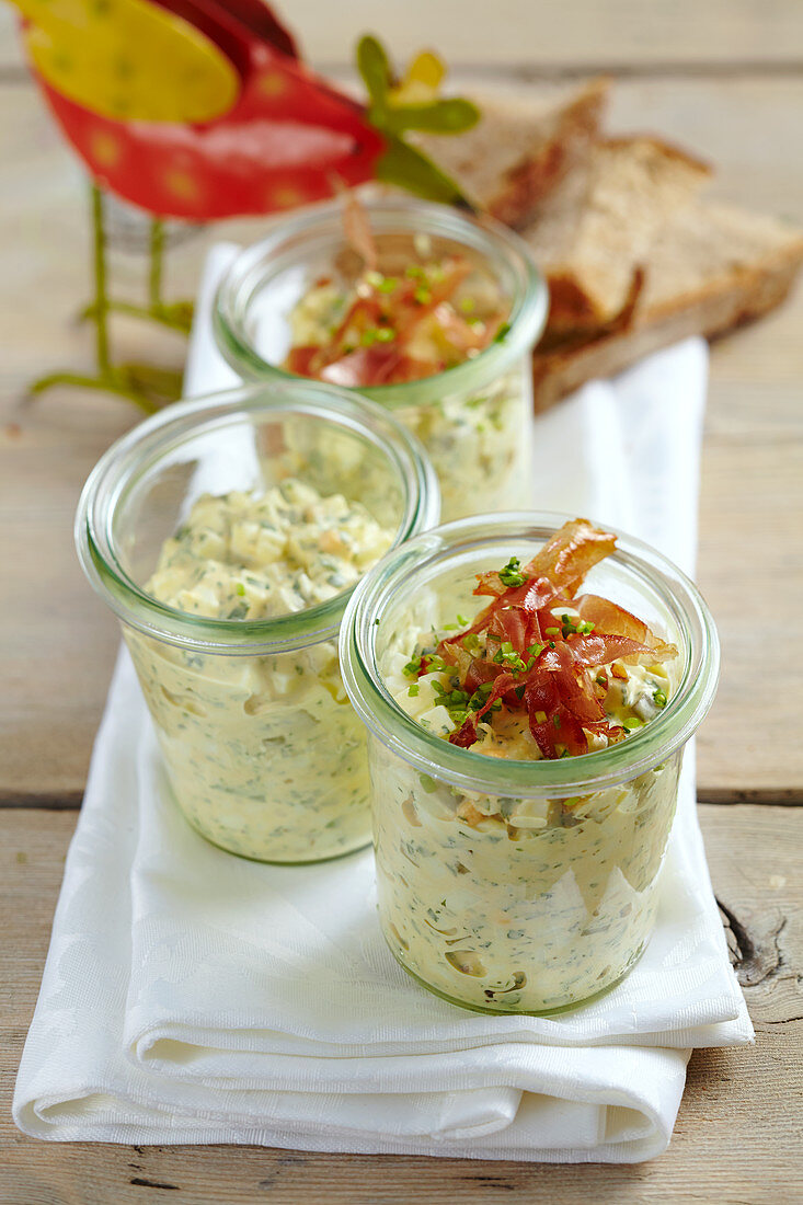 Egg salad in glasses with crispy fried Parma ham for an Easter brunch