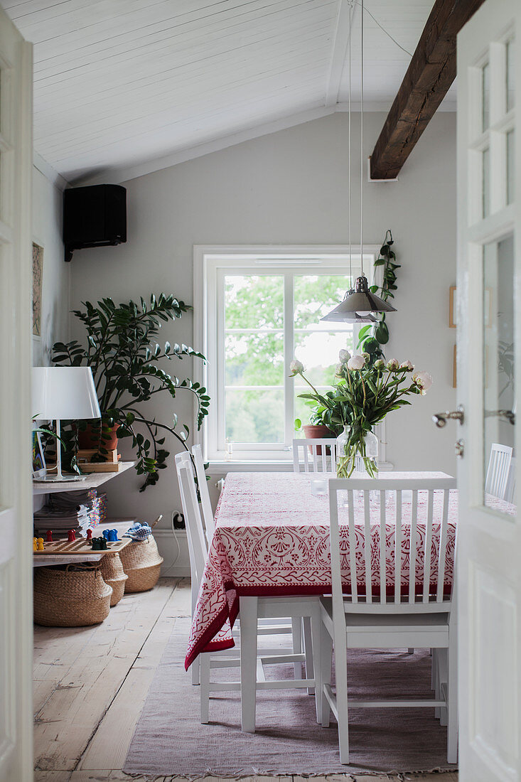 Rustic dining room with ceiling beam and lattice windows