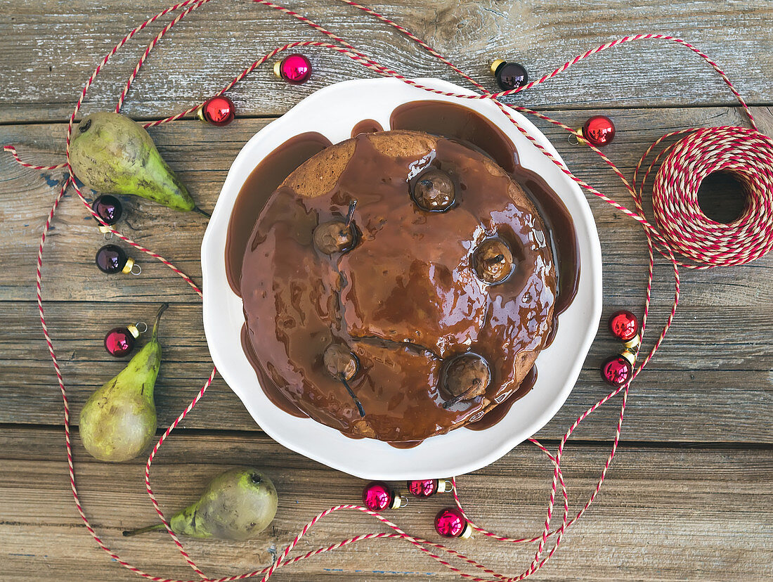 Christmas pear, ginger and honey cake with creamy caramel topping, fresh pears and Christmas decoration