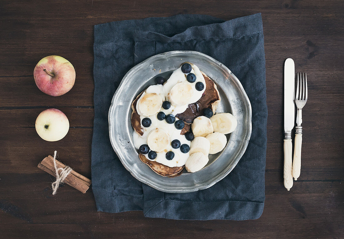 Pancakes with chocolate, yogurt, bananas and blueberries