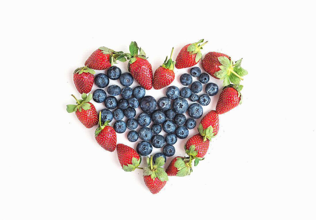 Heart sign made of fresh blueberries and strawberries