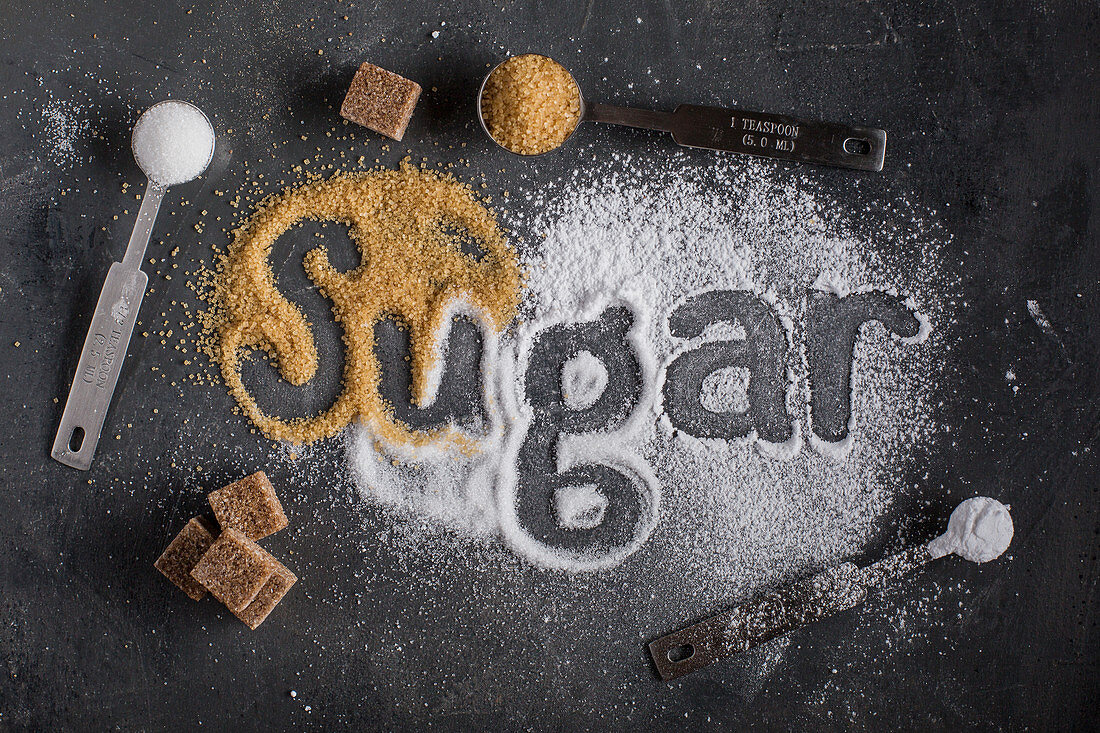 Three types of sugar and the word Sugar written with them