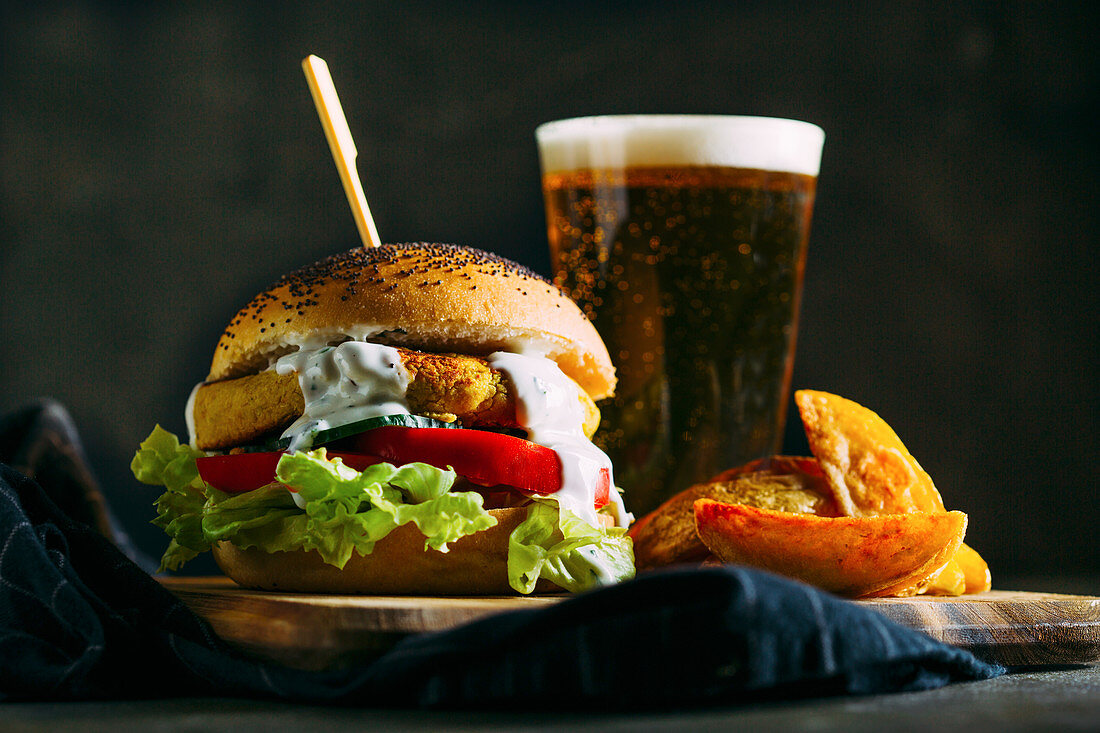 Vegetarian chickpea burger, with fries and a glass of beer