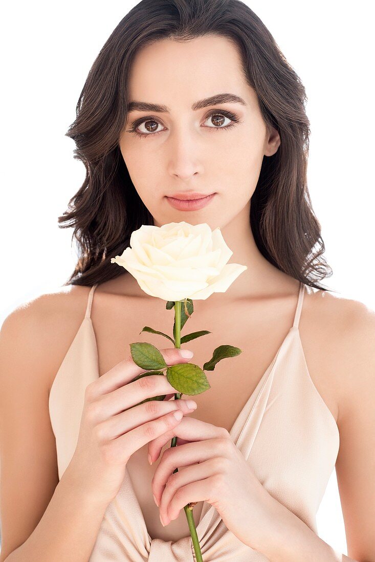 Woman holding white rose