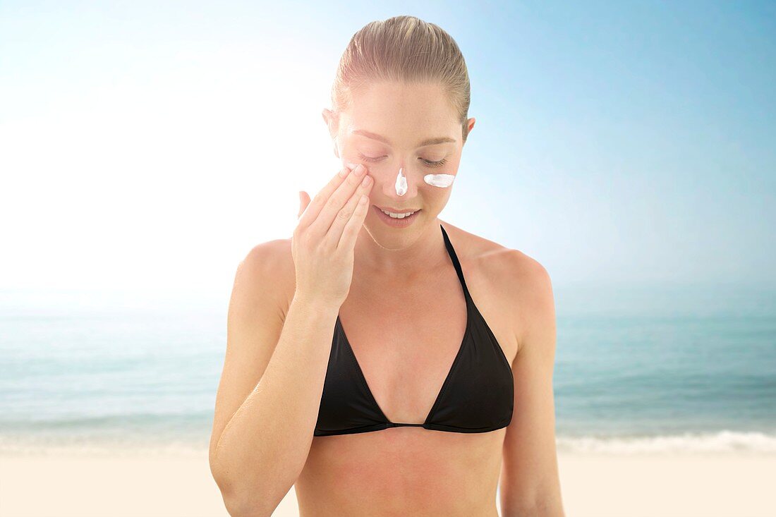 Woman applying sunscreen
