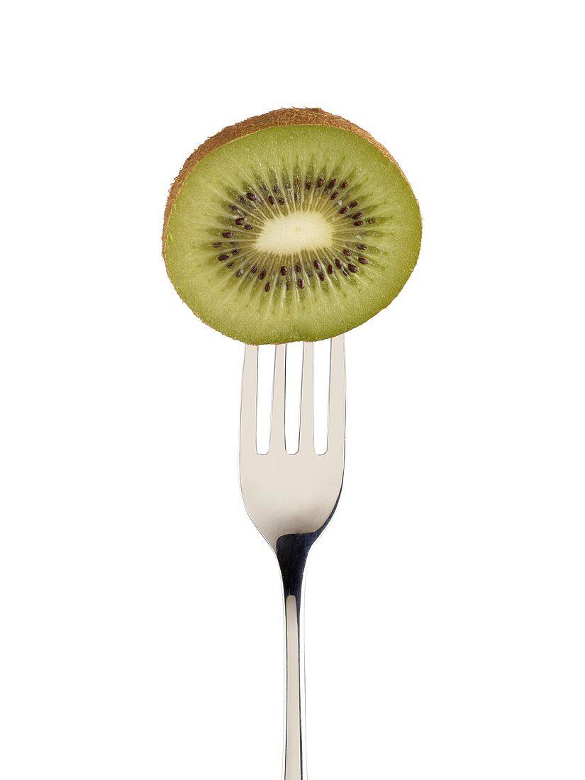 Kiwi cut in half on a fork