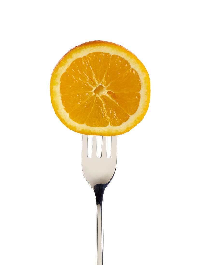 Orange cut in half on a fork