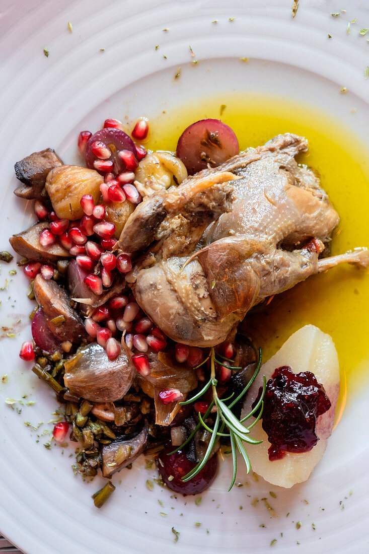 Portuguese Mediterranean dish of roast chicken in olive oil served with rosemary and pomegranate (Portugal)