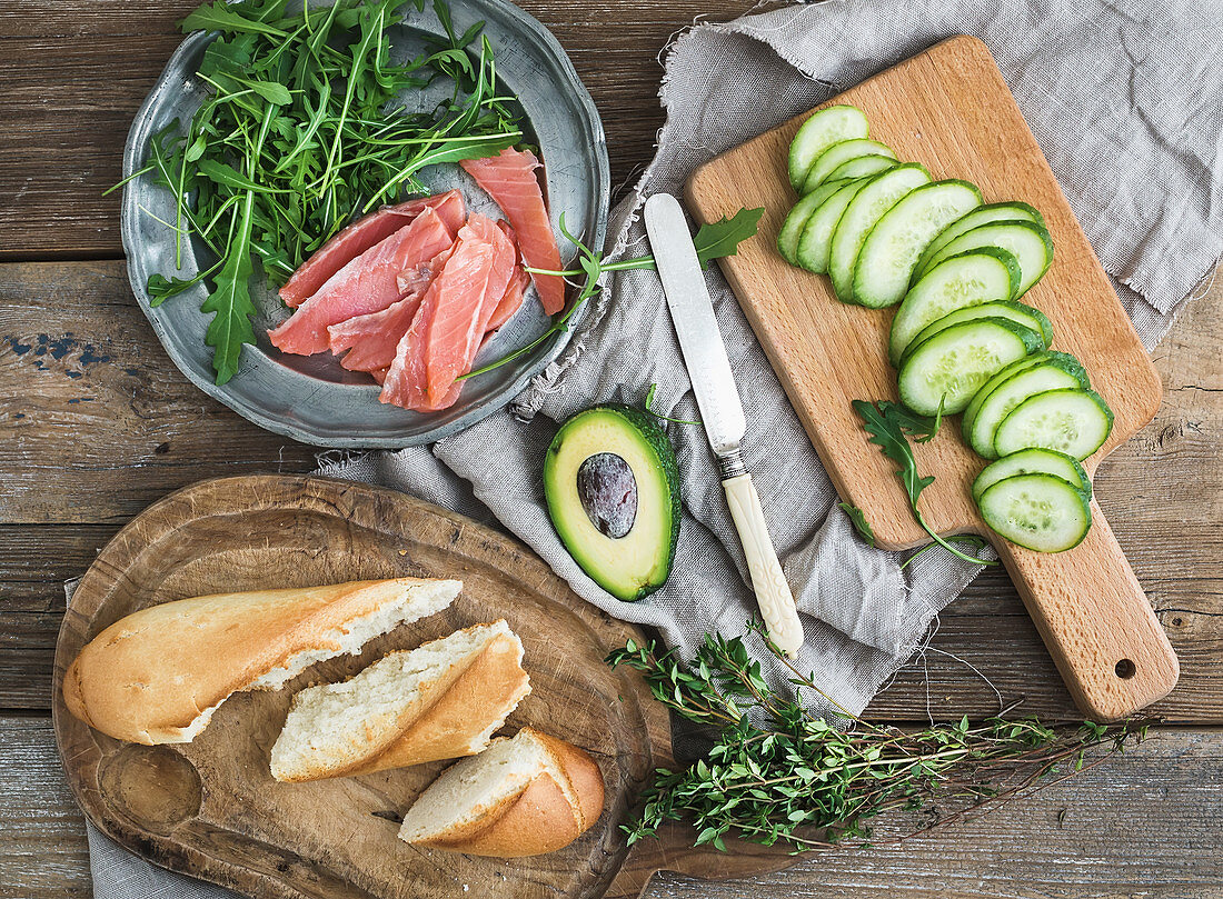 Salmon and avocado sandwiches with fresh thyme in baguette
