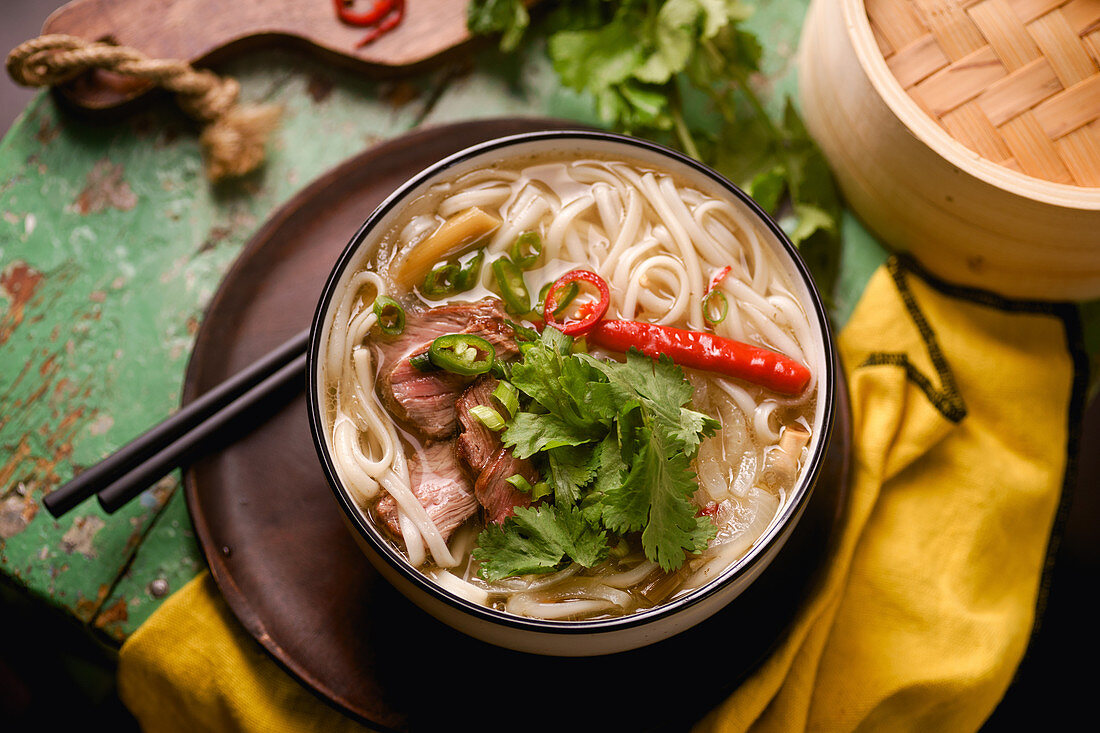 Vietnamese traditional soup Pho Bo with beef and fresh coriander