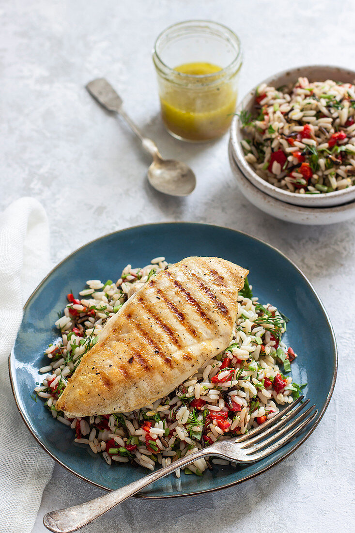 Rice salad with roasted pepper, chilli, dill, parley and lemon dressing and grilled chicken breast