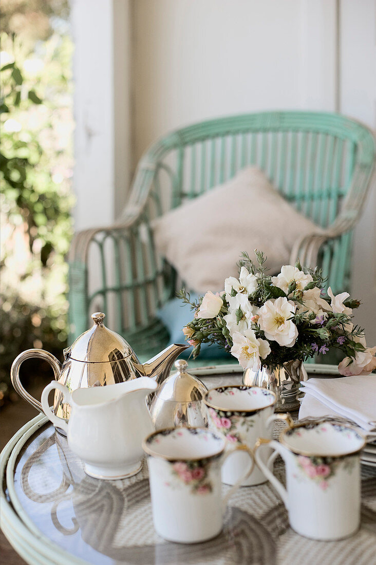 Table set with vintage crockery for afternoon coffee on terrace