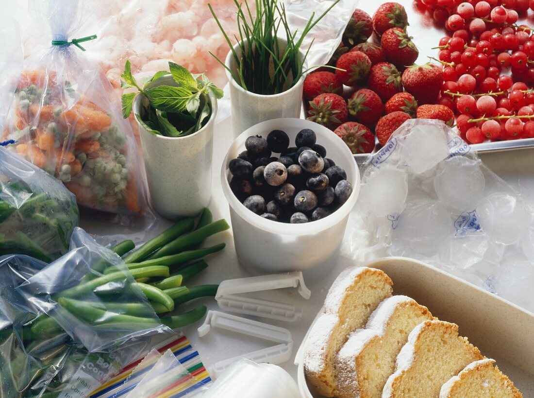 Cakes, vegetables, fruit, herbs, shrimps in freezer containers