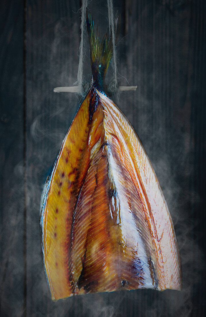 A kipper fish (smoked herring) being smoked in a smoker