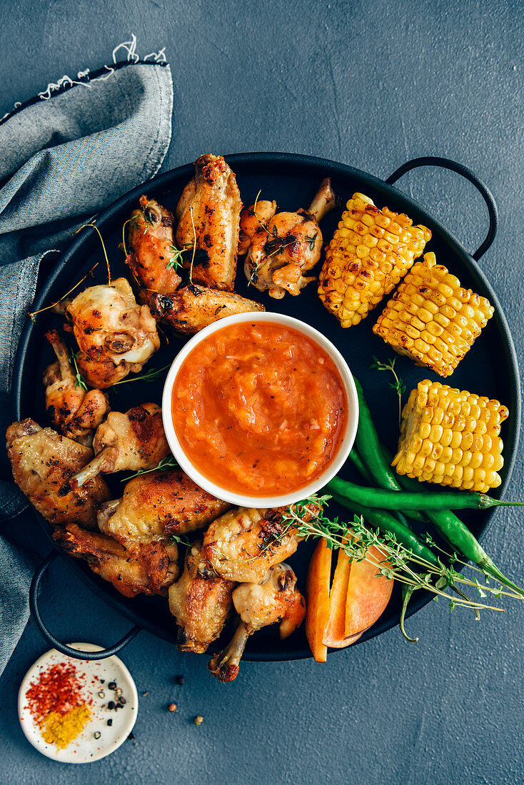 Grilled chicken wings with grilled corn, green peppers, fresh thyme, peach slices and sugar free bbq sauce