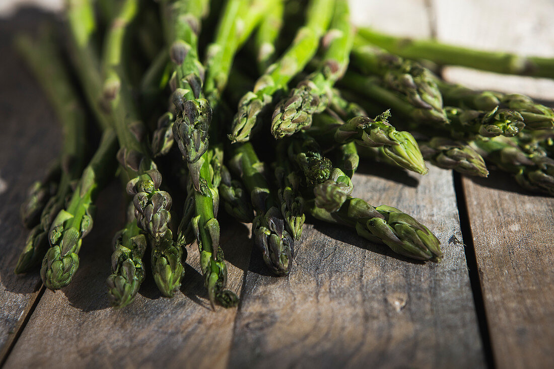 Fresh green asparagus on a wooden board