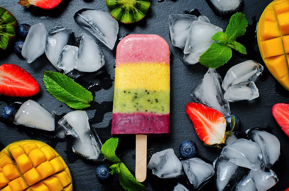 Strawberry, mango, kiwi and blueberry ice cream pop with fruits