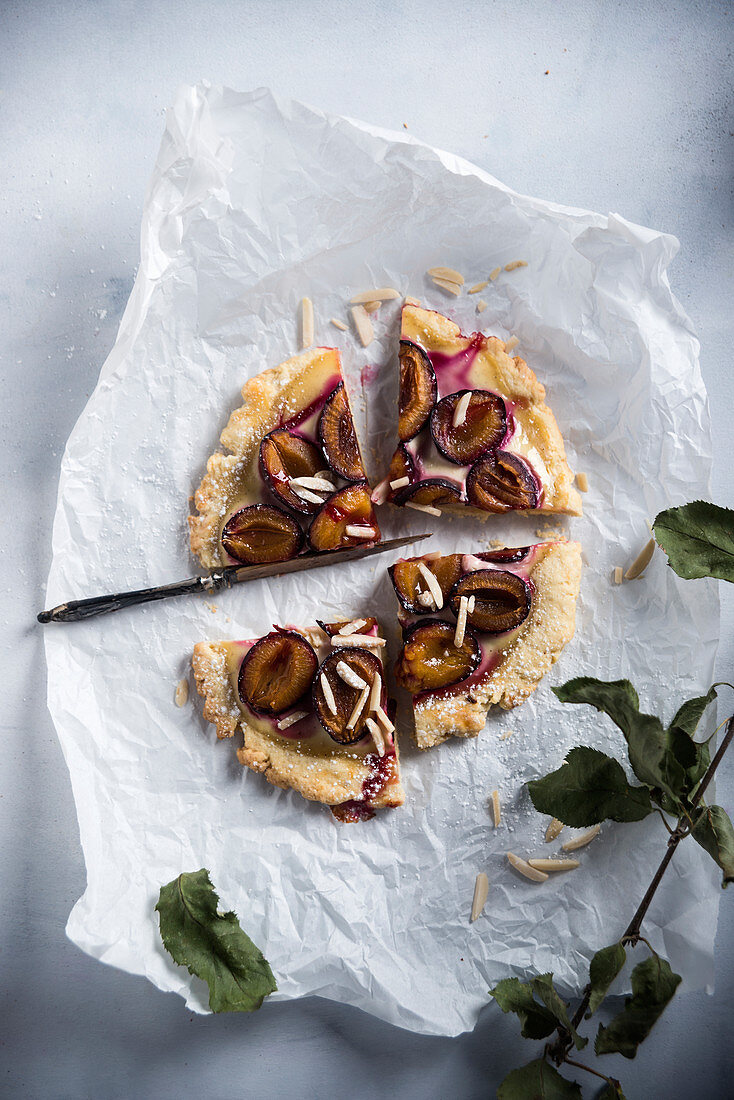 Vegan shortcrust pastry topped with damsons and almonds