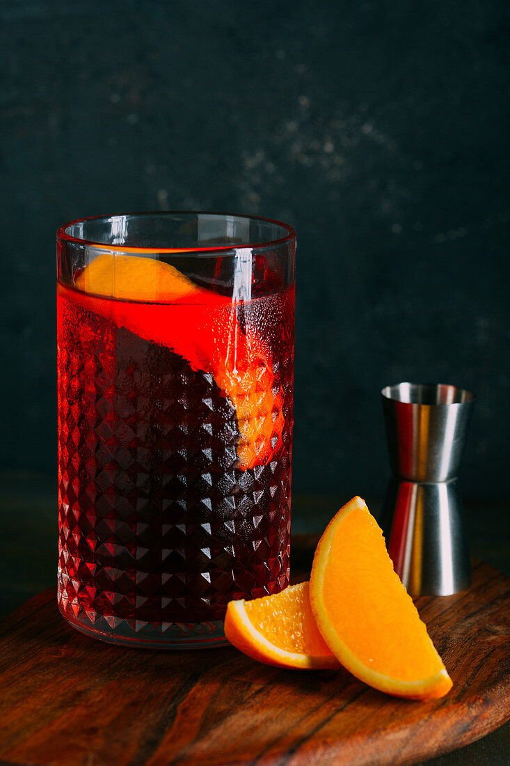 Negroni cocktail (old fashioned) with gin, vermouth and campari, decorated with an orange twist