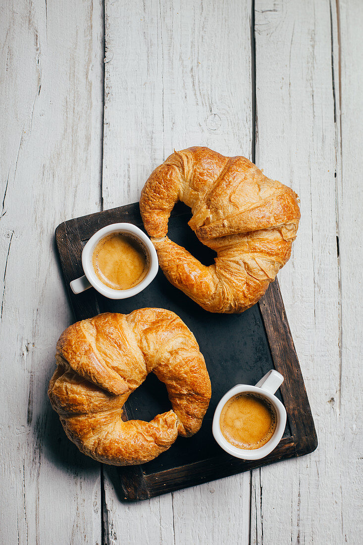 Espresso coffee cups and croissants