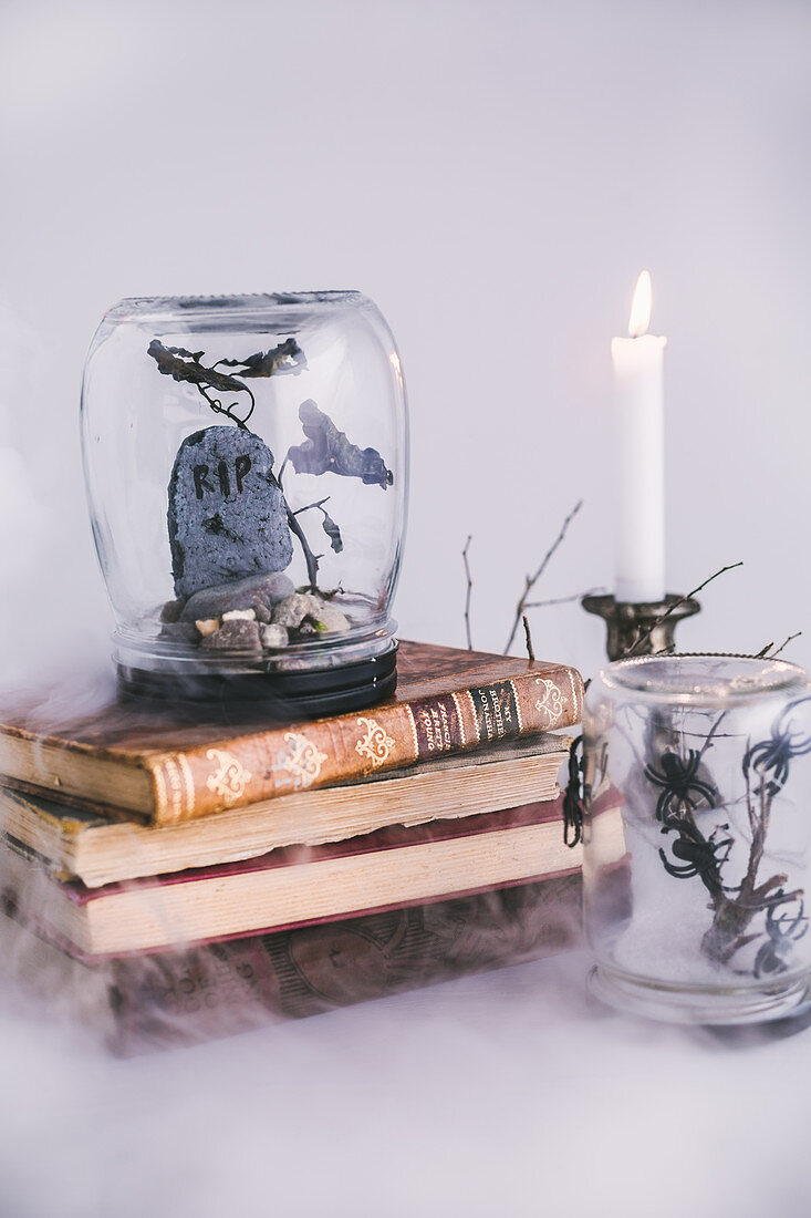 DIY Halloween decoration made from screw-top jars, branches and pebbles