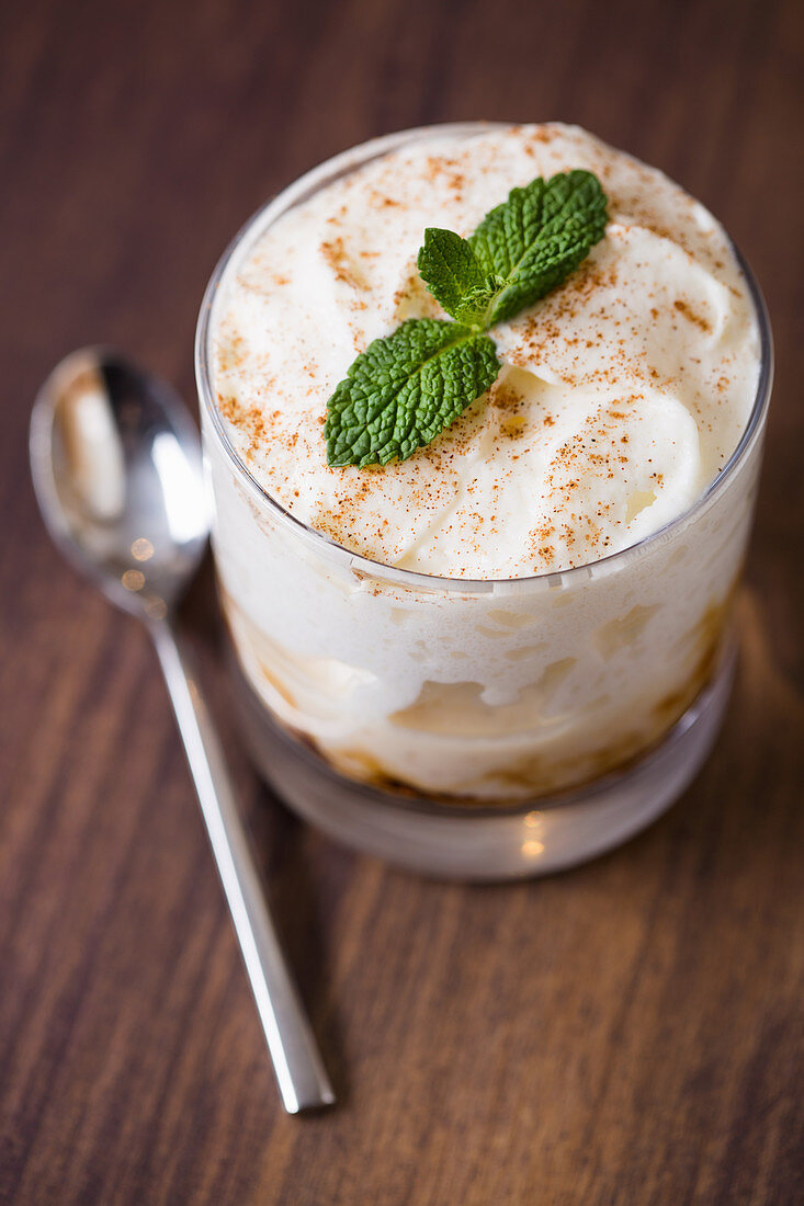 Rice pudding in a glass with cinnamon and mint