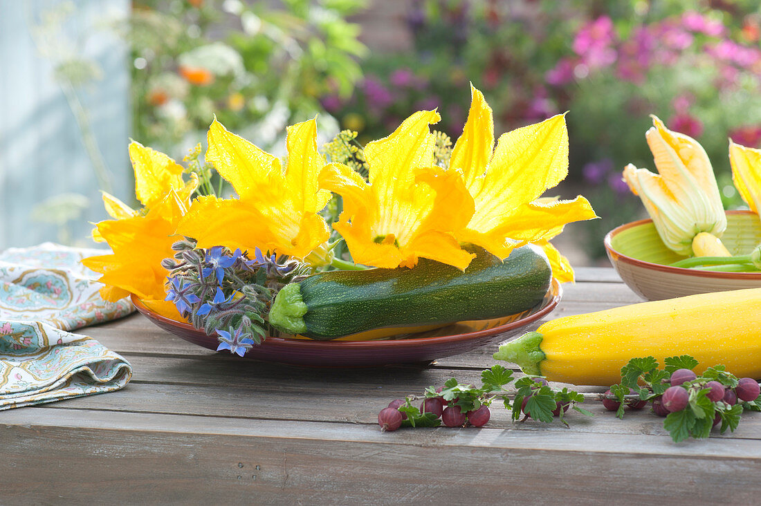 Plate of zucchini, zucchini flowers and borage