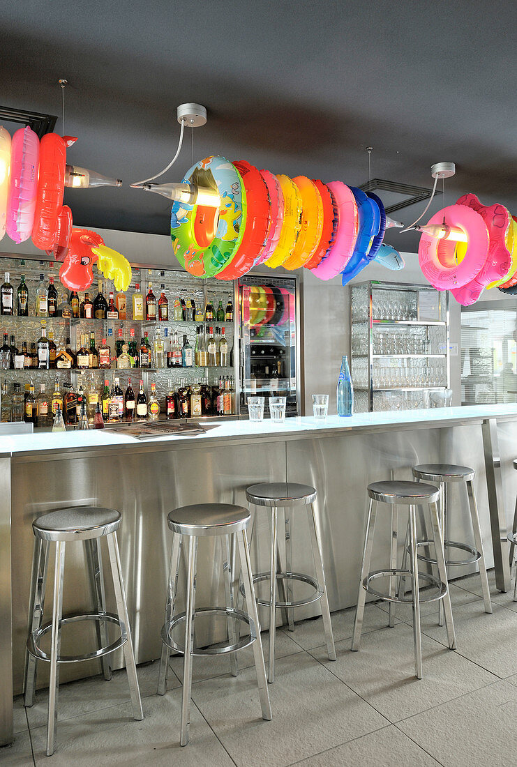 Colourful rubber rings above counter in bar