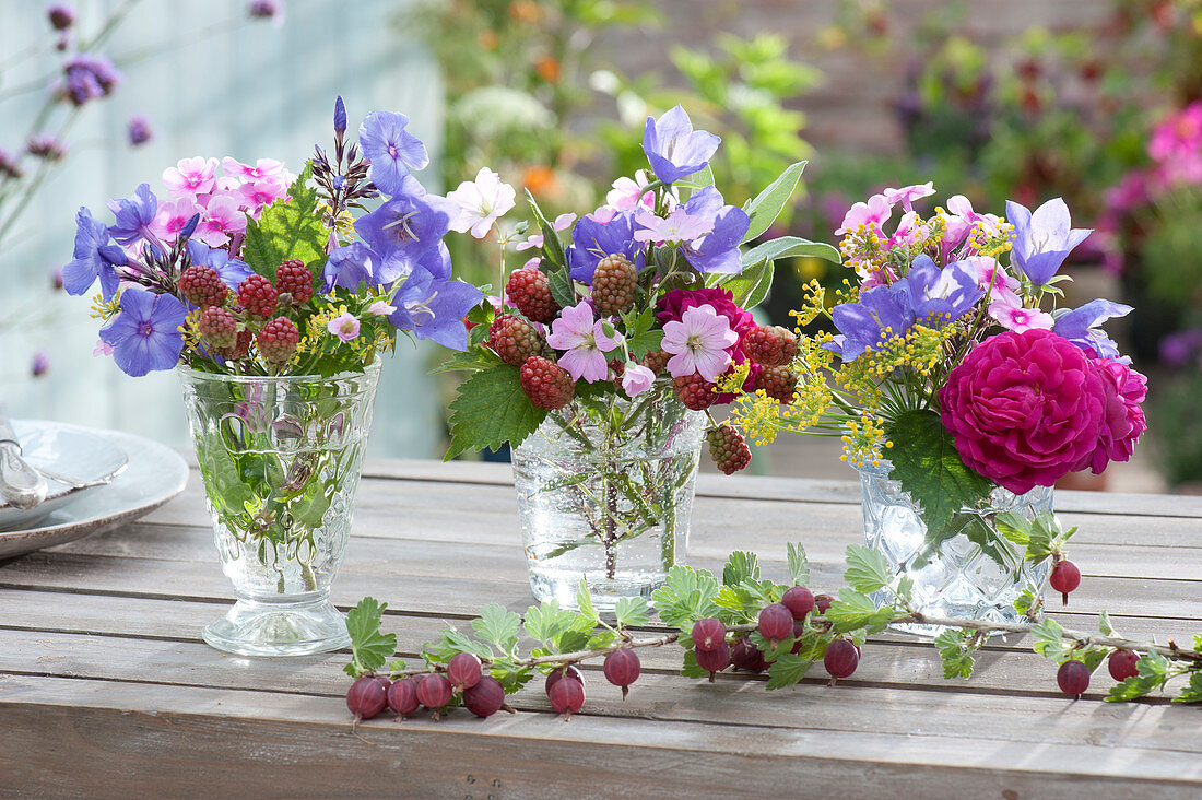 Small bouquets of roses, bluebells, phlox, mallow and blackberries