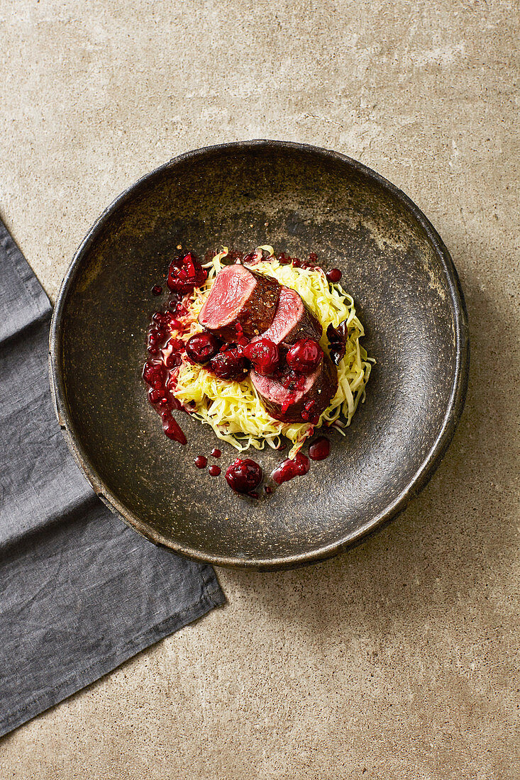 Marinated saddle of venison with pepper cherries and pointed cabbage
