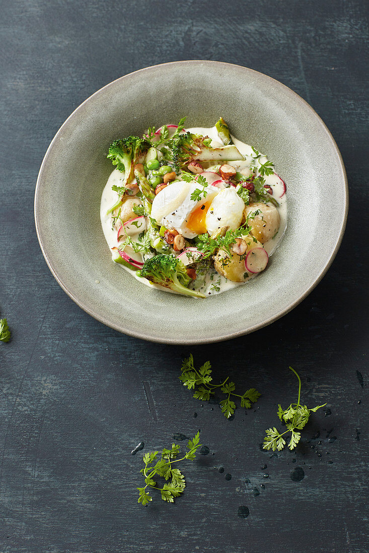 Asparagus and pea ragout with poached egg and wild broccoli