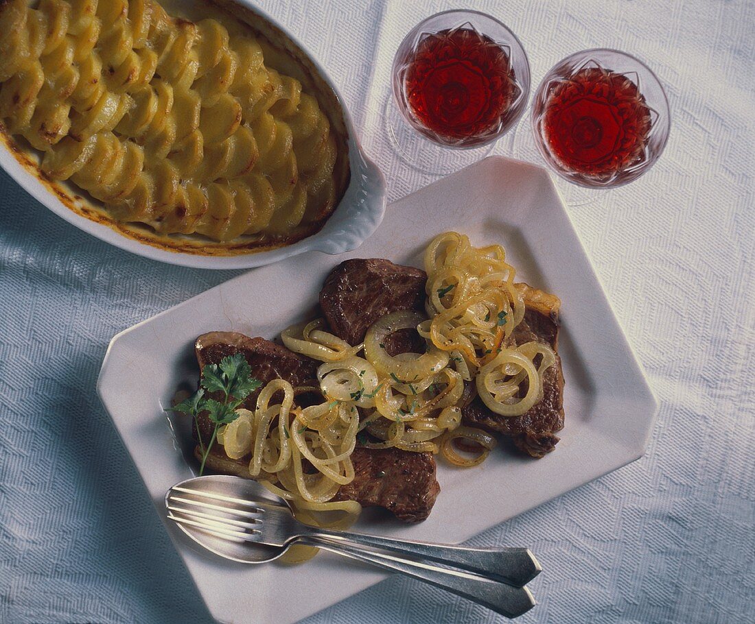 Steak with onions and potato gratin (Italy)