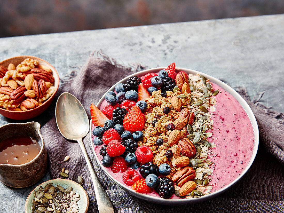 Breakfast bowl with blueberry, blackberry, strawberry, nuts and granola