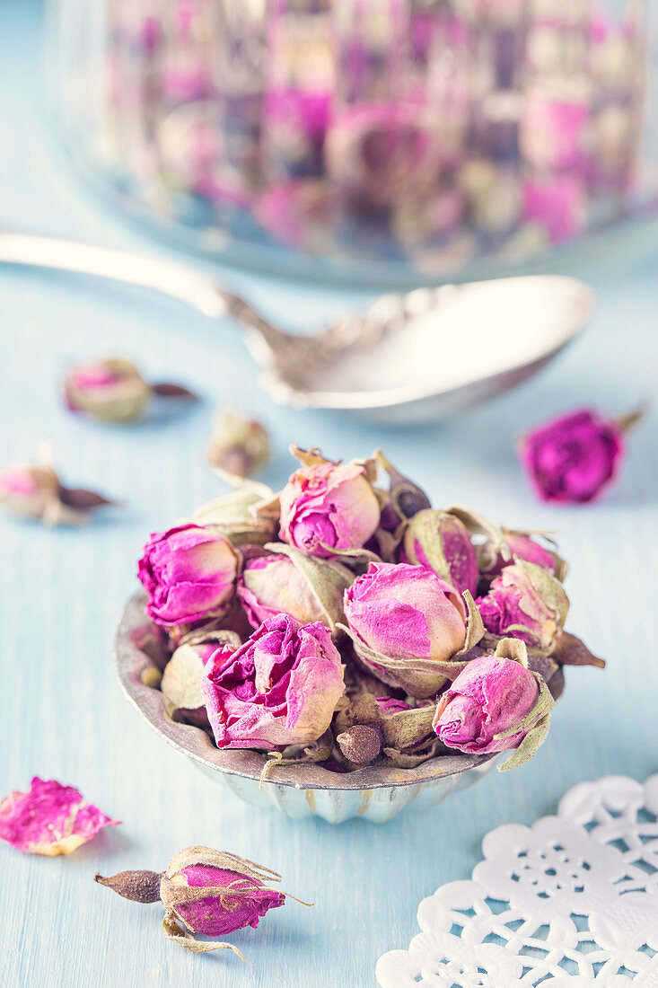 Dried rosebuds for tea in an old muffin tin
