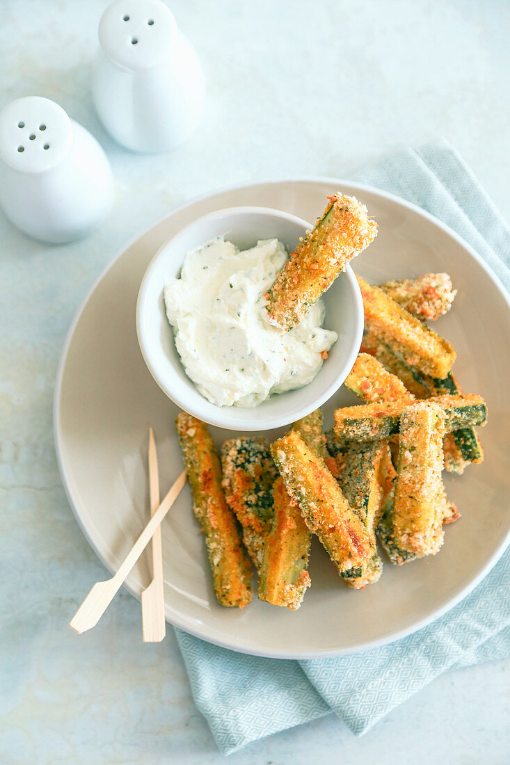Stick of breaded and oven-baked zucchini with ricotta and mayonnaise cream