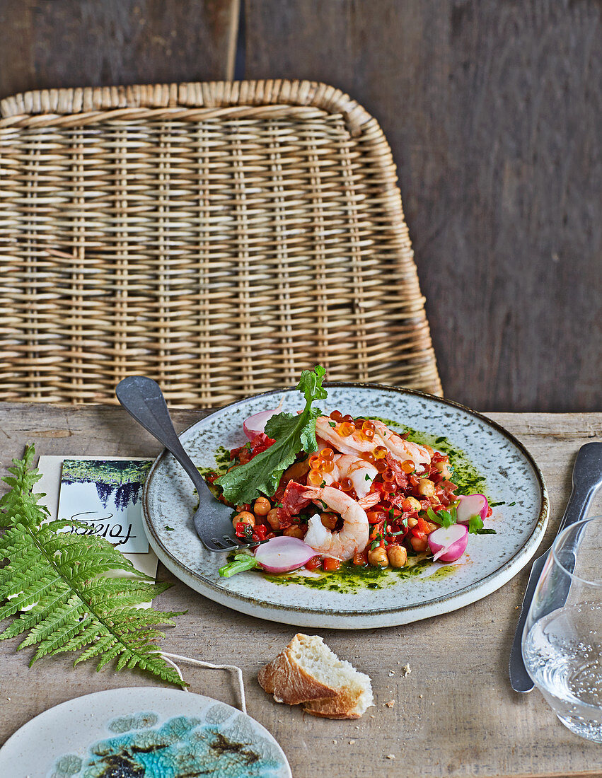 Prawns on a tomatoey chickpea and chorizo medley served with salmon caviar