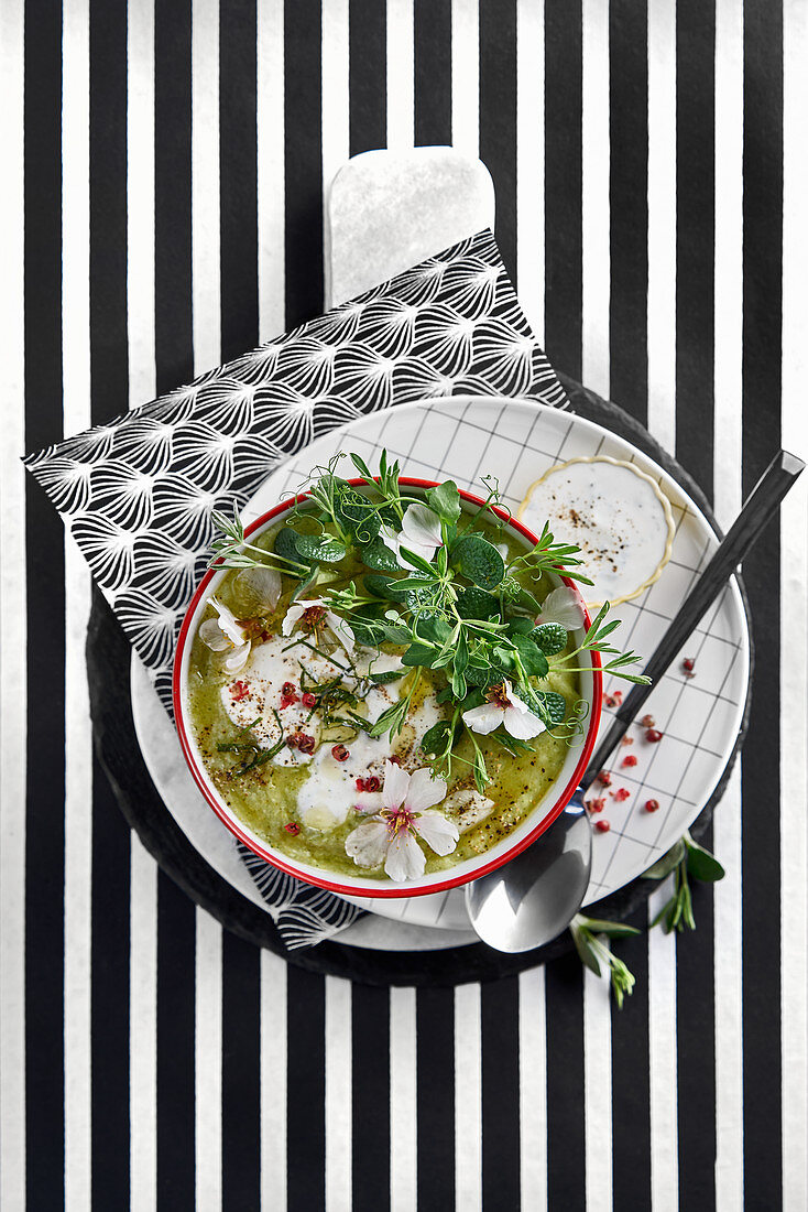 Green soup with edible flowers