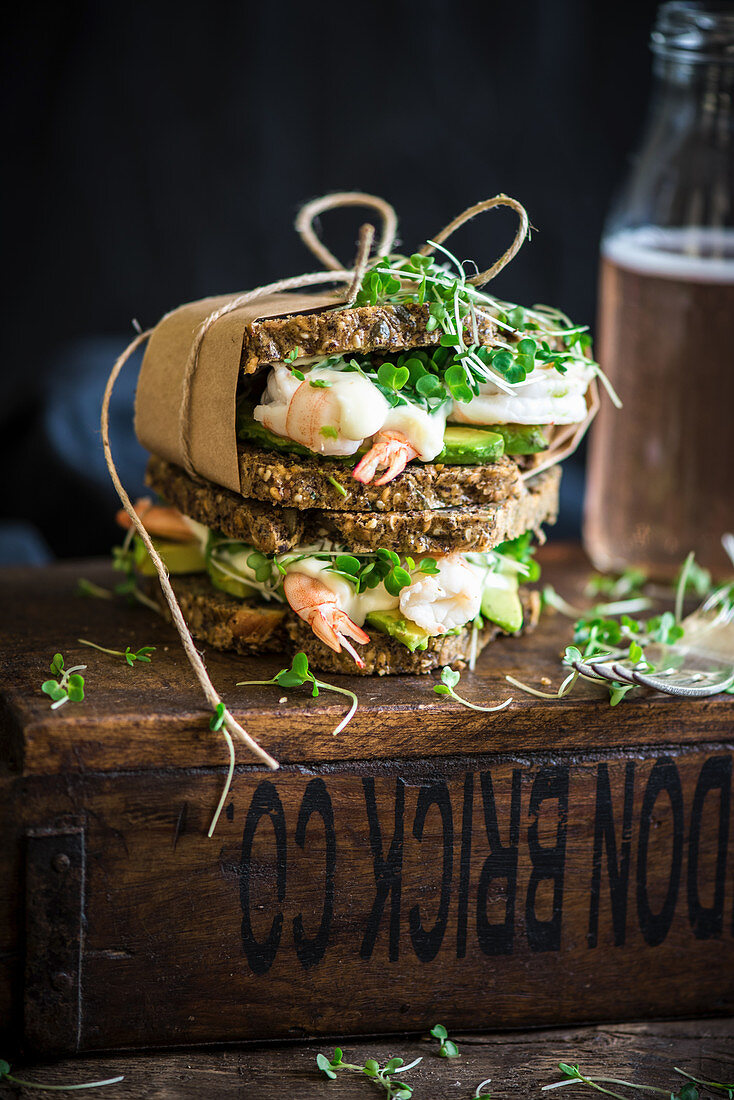 Prawn sandwich on a crunchy health bread with kombucha in the background