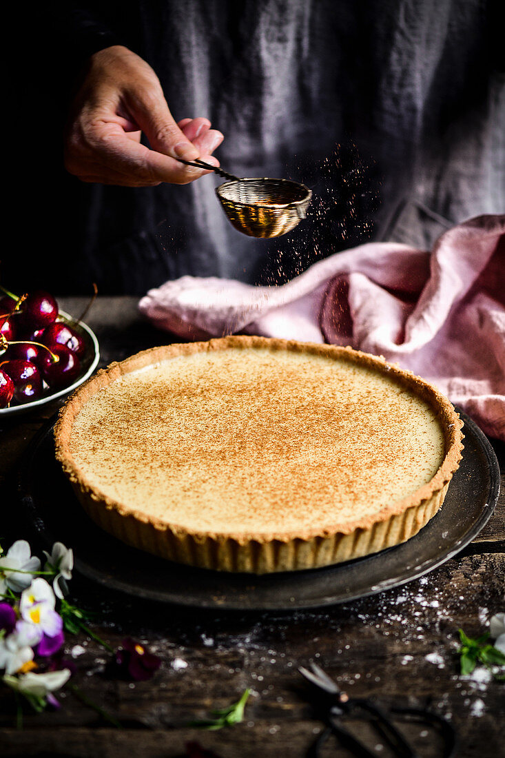 A dusting of cinnamon over a tart