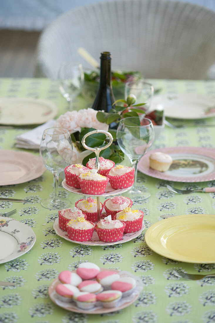 Muffins on cake stand on summery set table