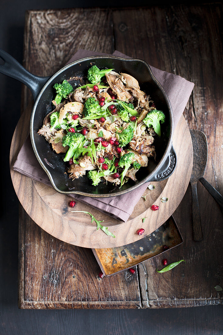 Pulled pork salad with broccoli and pomegranate seeds