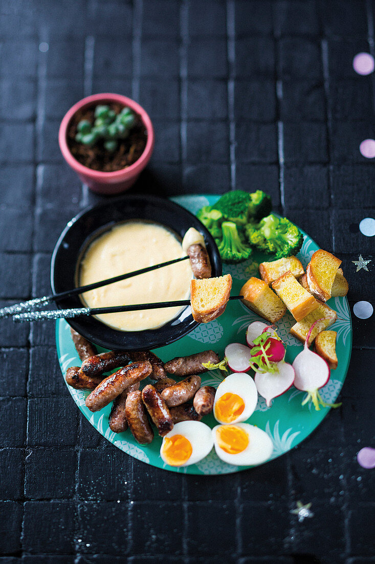 Cheesy fondue with sausages and vegetable