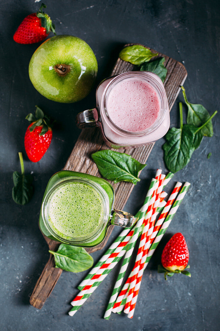 Green detox smoothie with apple and spinachs and pink smoothie with berries