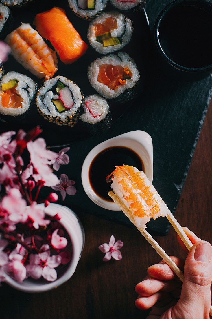 Hand picking a piece of Sushi