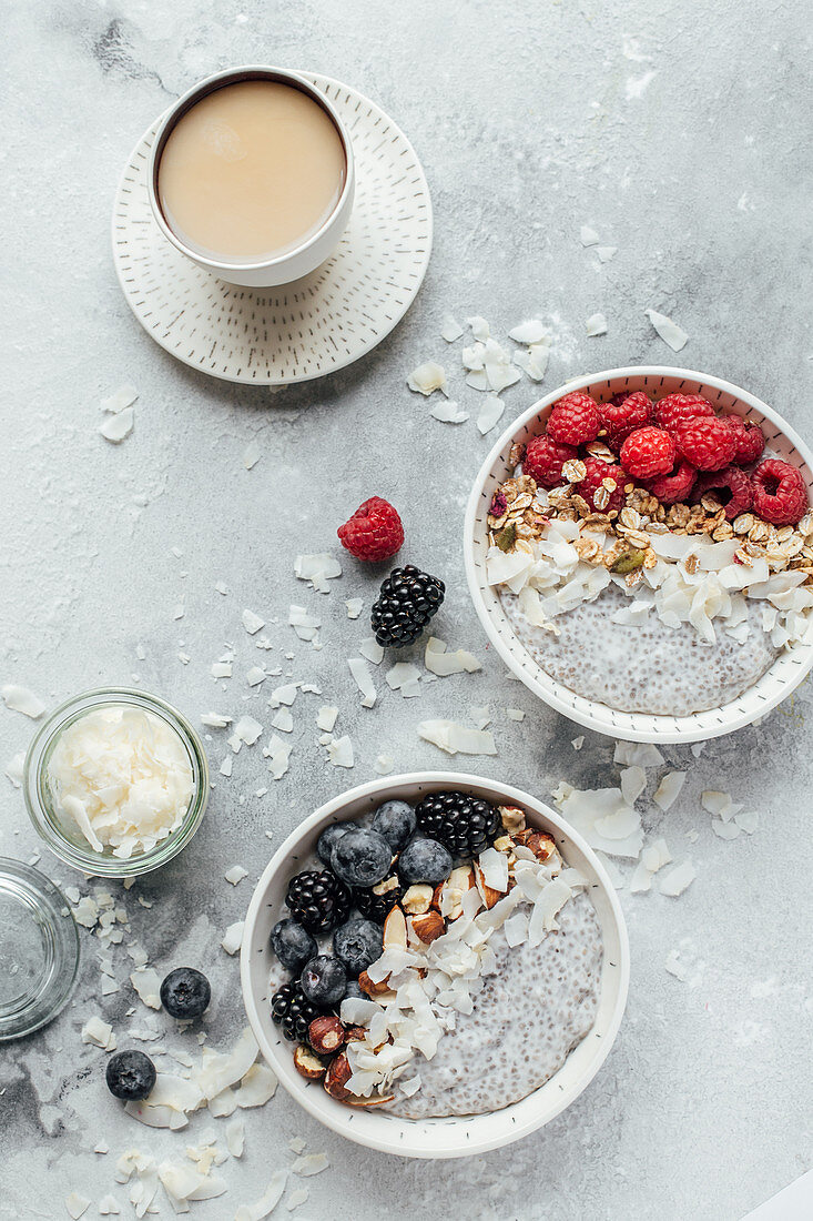 Chia pudding with coconut milk, berries, nuts, granola and coffee