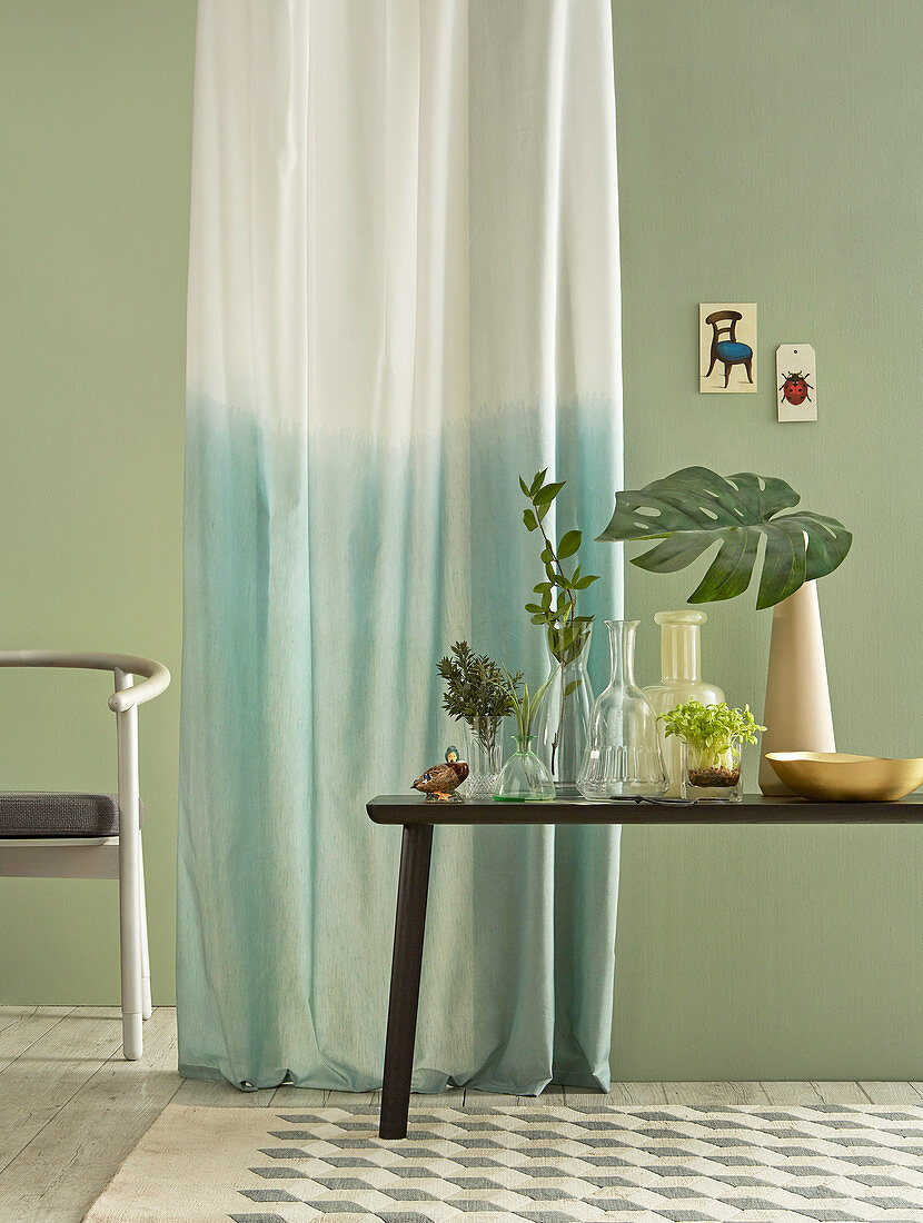 Ombré curtain against pale green wall