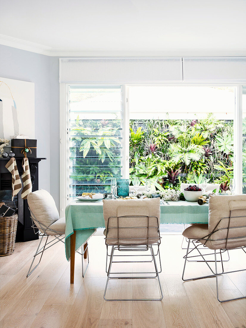 Metal chairs with pillows around laid table